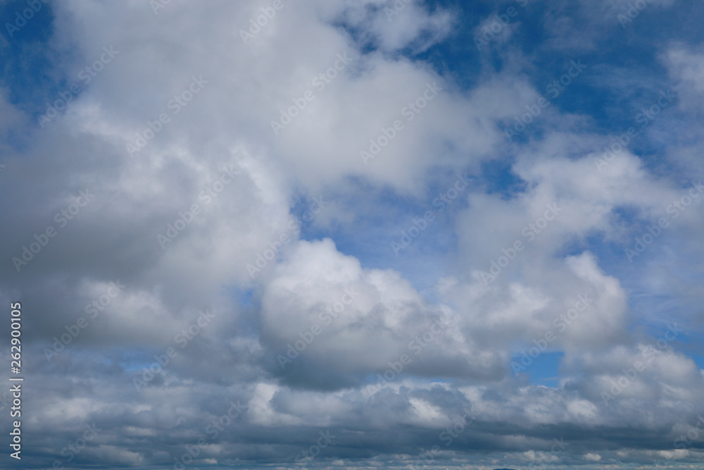 blue sky with white clouds to horizon