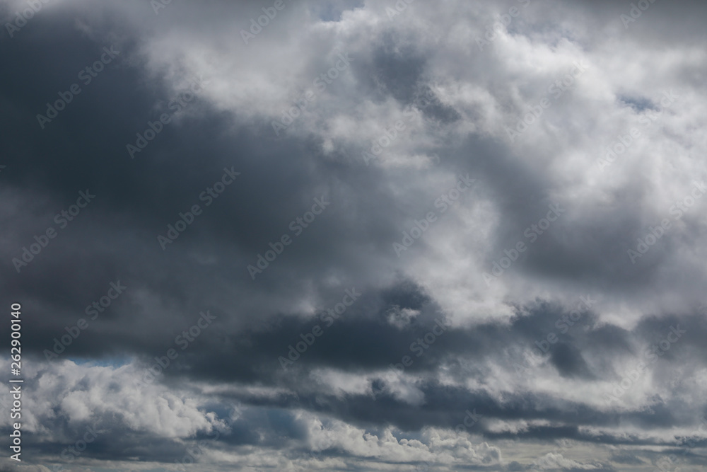 Dramatic sky with grey and white clouds to horizon