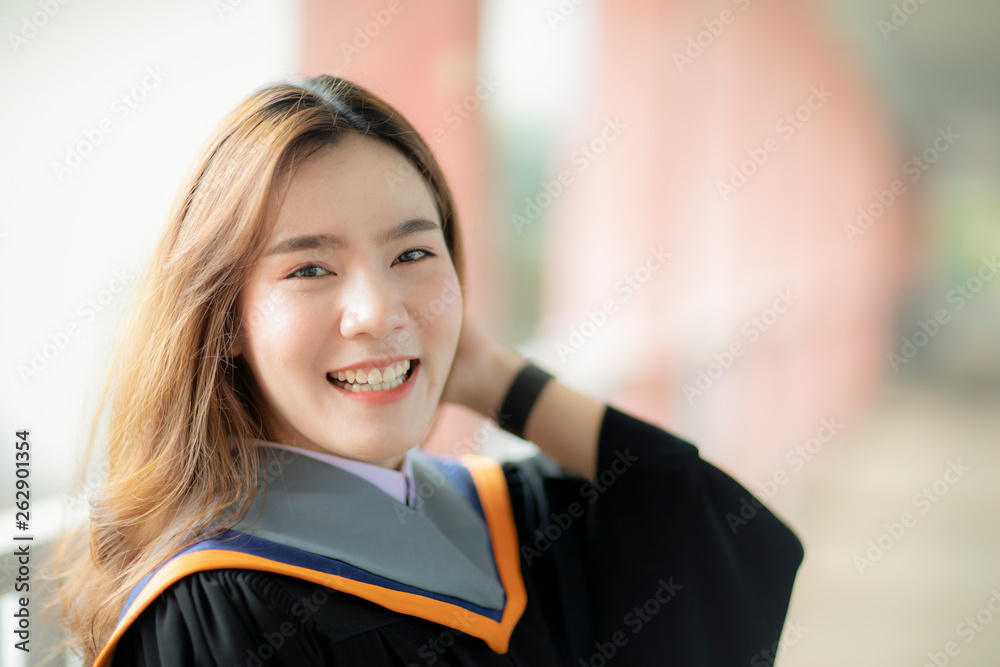 toothy smiling face of beautiful asian younger woman wearing university graduated clothes happiness emotion