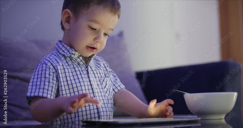 Cute Child Entertaining With Tablet. Little Boy Spending Leisure Time Playing Mobile Game in the and Crushes the Bright Screen With Her Hand. Concept of:Happy Childfood, Technology, Childen Play Games Cute Child Entertaining With Tablet. Little Boy Spending Leisure Time Playing Mobile Game in the and Crushes the Bright Screen With Her Hand. Concept of:Happy Childfood, Technology, Childen Play Games