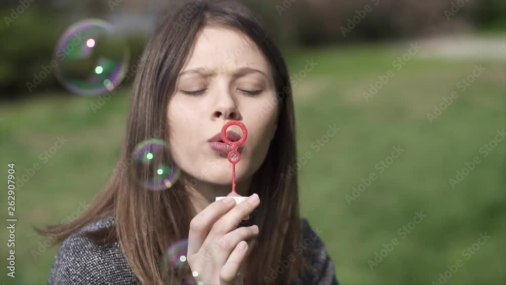 Beautiful young Woman making Soap Bubbles and having fun in the Park, Slow motion clip Beautiful young Woman making Soap Bubbles and having fun in the Park, Slow motion clip