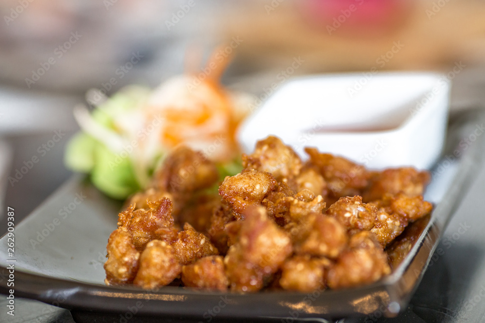 Blurred background of food (fried pork, fried chicken, french fries) served to customers and decorated with beautiful dishes for more appetizing