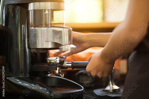 Employees working with coffee makers.