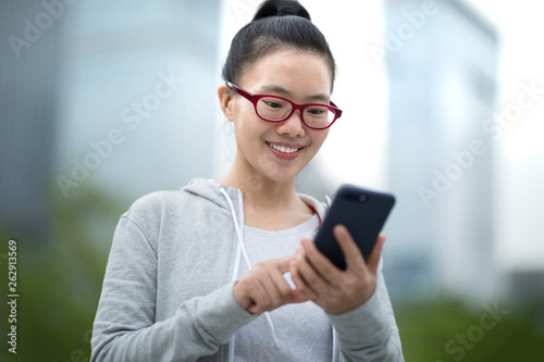 woman using smart phone on city