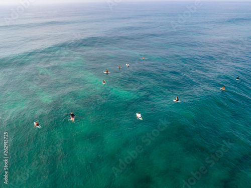 Photography Aerial view from drone of surfers for catching waves during surfing  in the indi