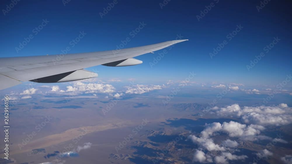 Airplane flight. Wing of an airplane flying above the clouds with sunset sky. View from the window of the plane. Aircraft. Traveling by air. Airplane flight. Wing of an airplane flying above the clouds with sunset sky. View from the window of the plane. Aircraft. Traveling by air.