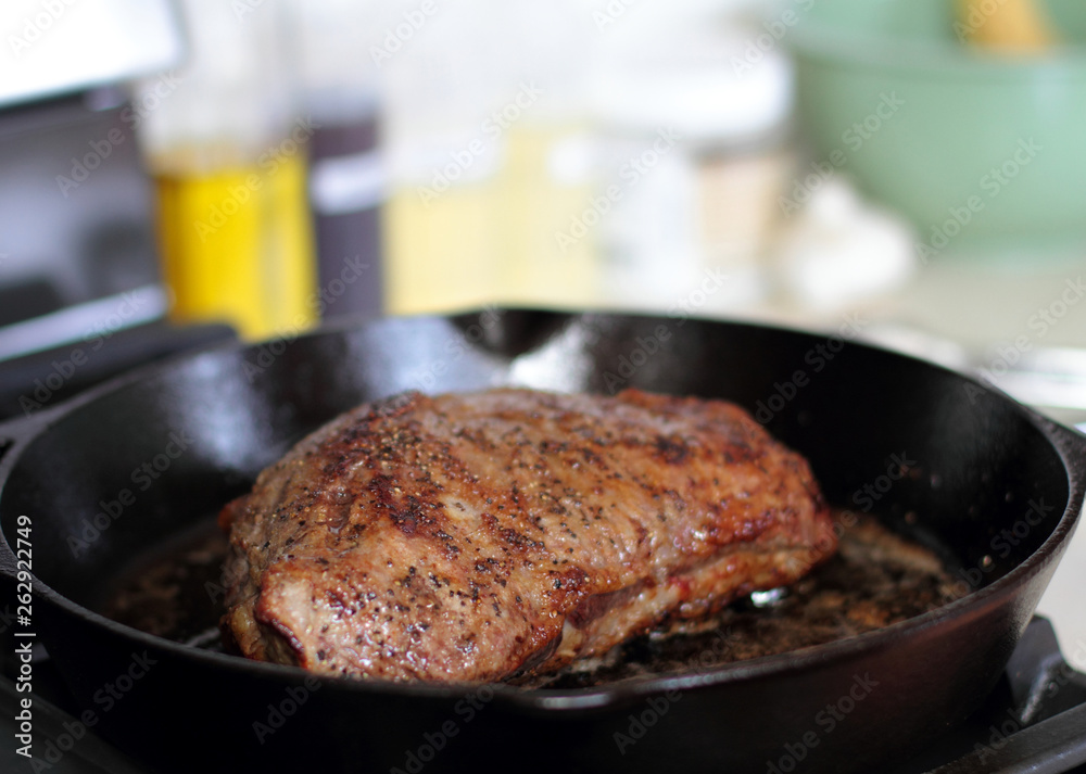 Fototapeta premium Tri-tip roast in a cast iron pan resting on the oven.