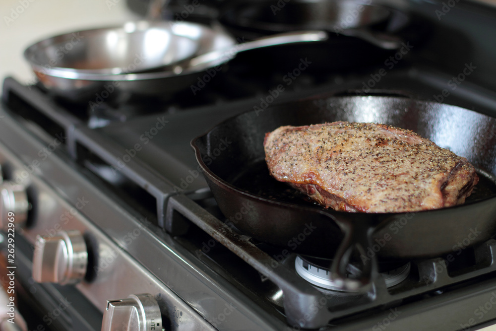 Tri-tip roast in a cast iron pan resting on the oven. Tri-tip roast in a cast iron pan resting on the oven.