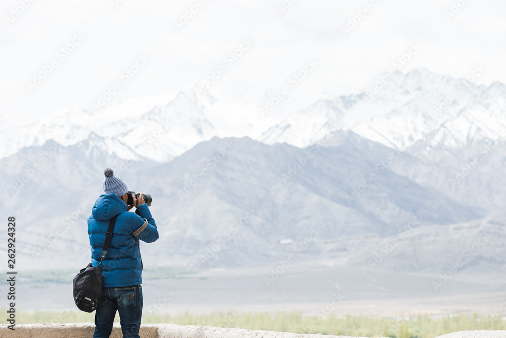 Nature photographer taking photos in the mountains Nature photographer taking photos in the mountains