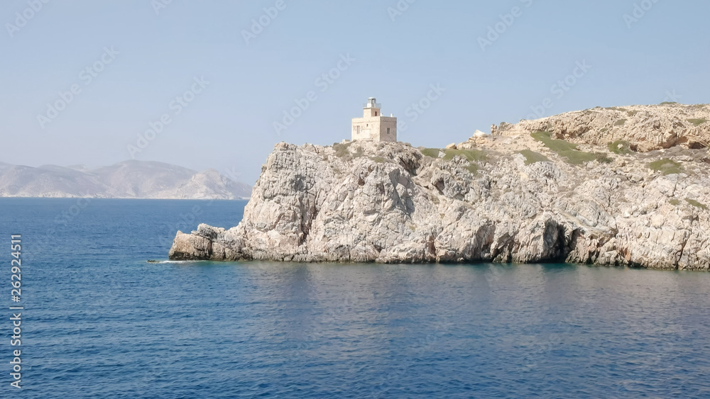 lighthouse ormos harbor on the island of ios, greece