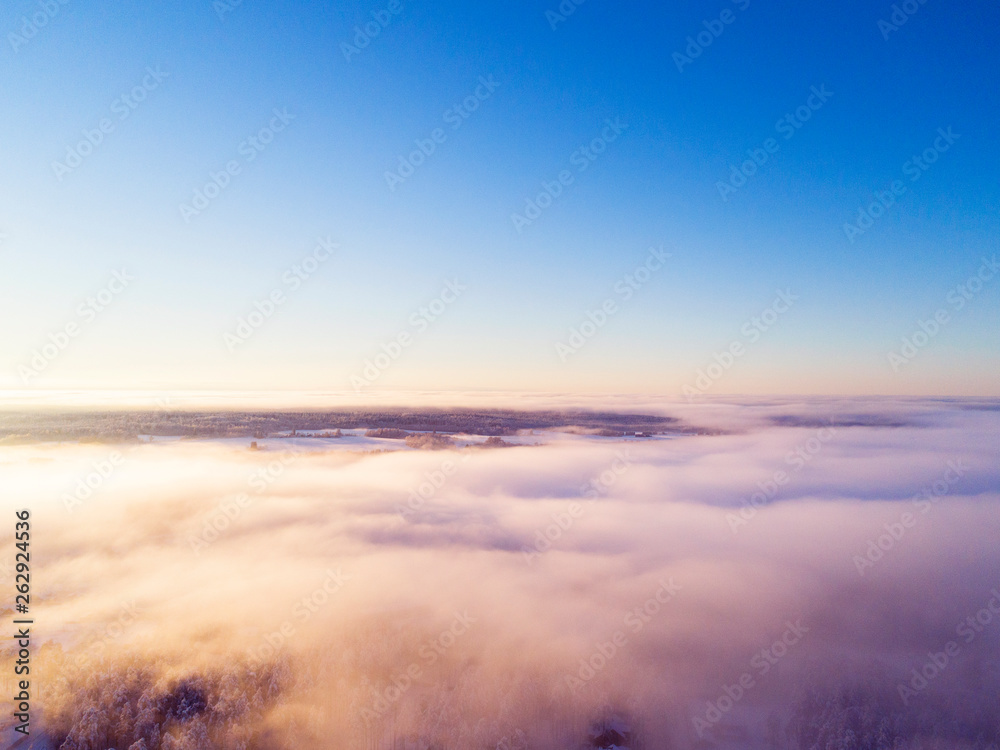Aerial view clouds over forest during winter colors. Aerial view of forest and clouds. Coastline. Aerial drone view of the forest. Aerial top view cloudscape. Texture of clouds.
