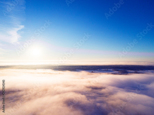 Aerial view clouds over forest during winter colors. Aerial view of forest and clouds. Coastline. Aerial drone view of the forest. Aerial top view cloudscape. Texture of clouds.
