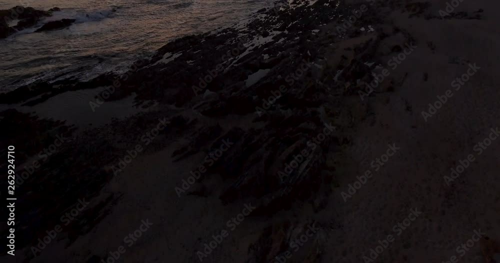 4K Reveal aerial shot of a beautiful coastline at sunset. 4K Reveal aerial shot of a beautiful coastline at sunset.