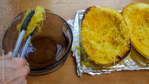 Spaghetti squash being put into a bowl. photo