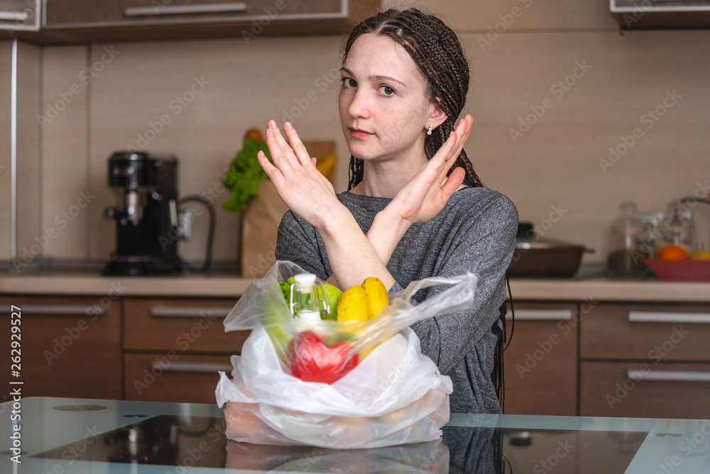 Woman thinks that refuse to use a plastic bag to buy products. Environmental protection and the abandonment of plastic