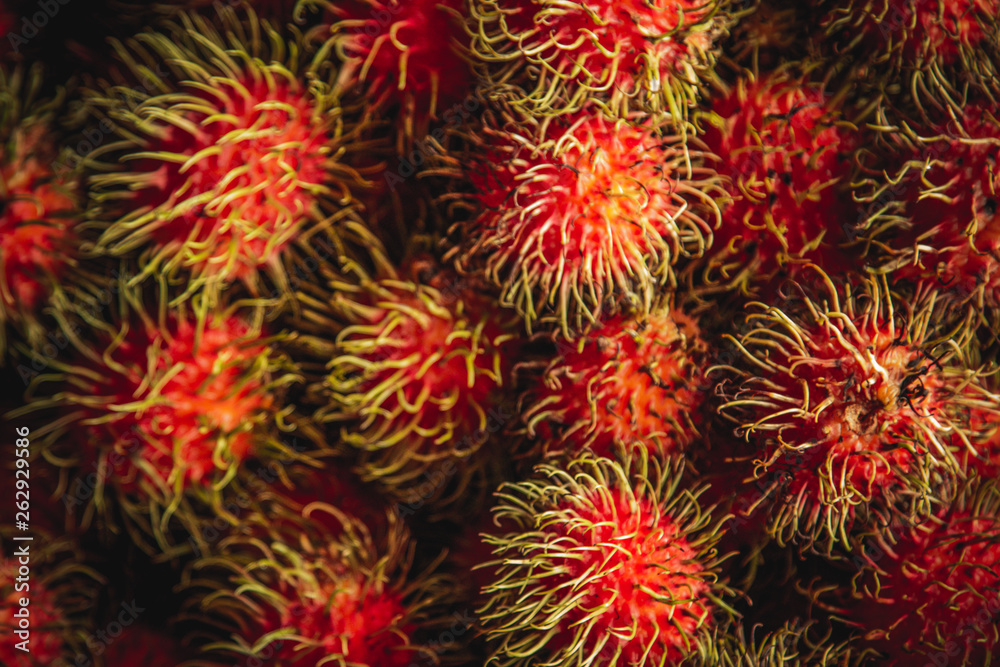 Healthy fruits rambutans background, Red Healthy fruits rambutans, rambutans in a supermarket Healthy fruits rambutans background, Red Healthy fruits rambutans, rambutans in a supermarket