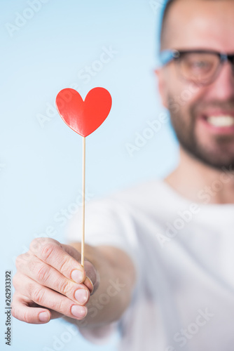 Adult man with heart on stick