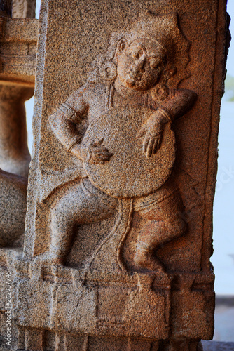 Sculpture of musician playing drum at the Vittala Temple, Hampi, Karnataka, India.