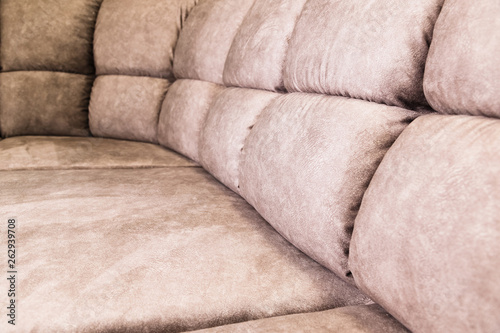 Fototapeta Naklejka Na Ścianę i Meble -  Close-up of an expensive soft textile sofa of beige color with brown shades. Interior Background