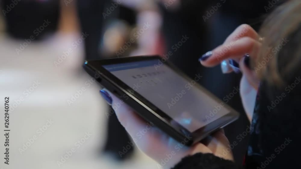 Arbitrator of the dance contest, using a digital tablet puts out scores Arbitrator of the dance contest, using a digital tablet puts out scores