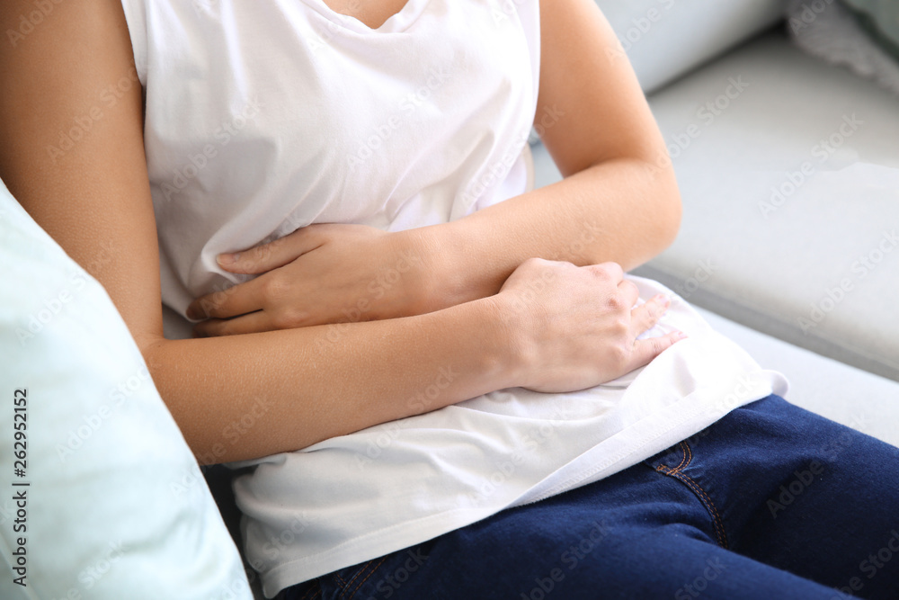 Young woman suffering from pain at home