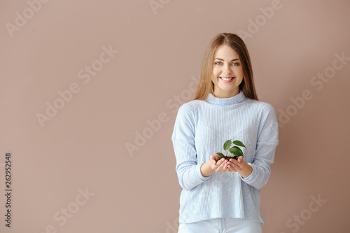 Woman with young plant on c...