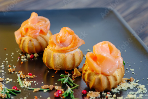 profiteroles with fish on a black background