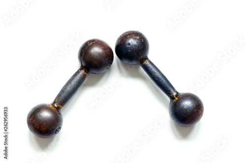 Two metal brutal dumbbells on a white background, top view close-up.