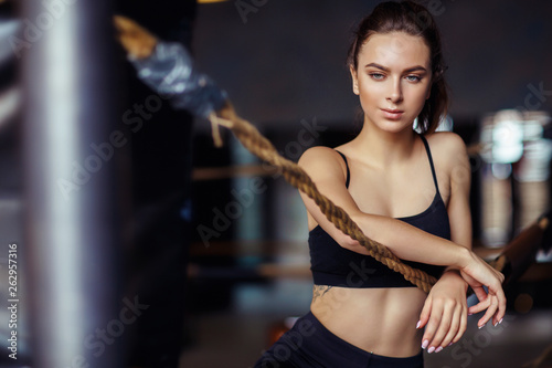 Portrait of young sports woman in black tracksuit