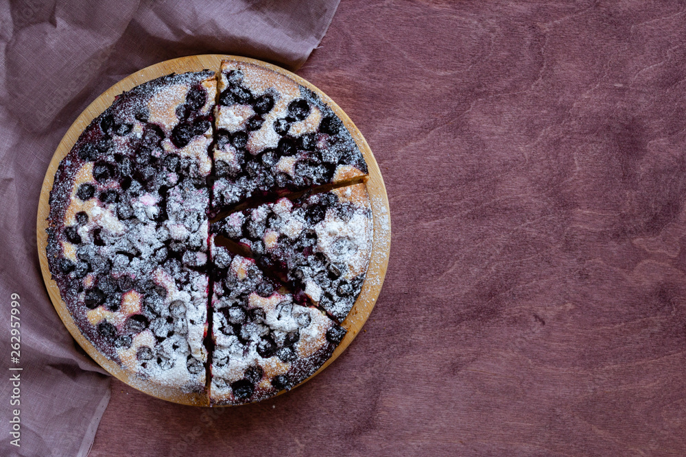 Homemade berry cake. Currant pie cut into pieces on a wooden brown table. Rustik style. Free space for text Homemade berry cake. Currant pie cut into pieces on a wooden brown table. Rustik style. Free space for text