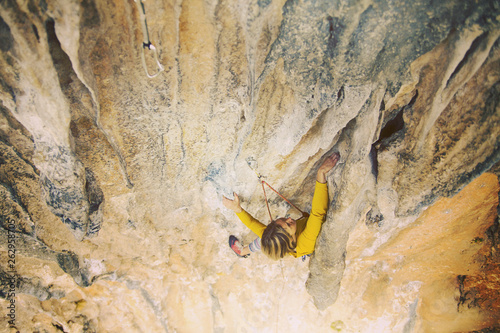 Wallpaper Mural The girl climbs the rock. Fitness in nature and rock climbing. The climber climbs up. Torontodigital.ca
