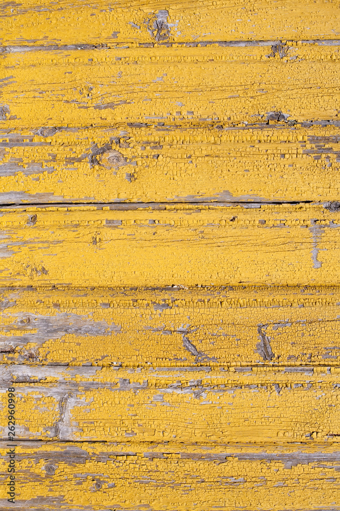 rustic wooden old flaked  yellow painted texture of planked wall pattern outdoor closeup