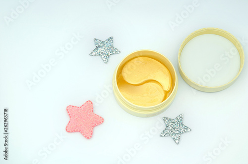 A bank of eye patches close-up with a shiny star on a white background.