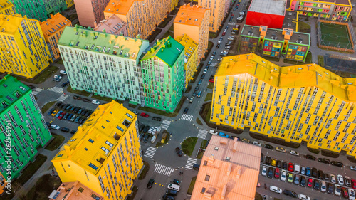 panoramic aerial view of colorful (red, green, blue, yellow) buildings on city street. drone shot