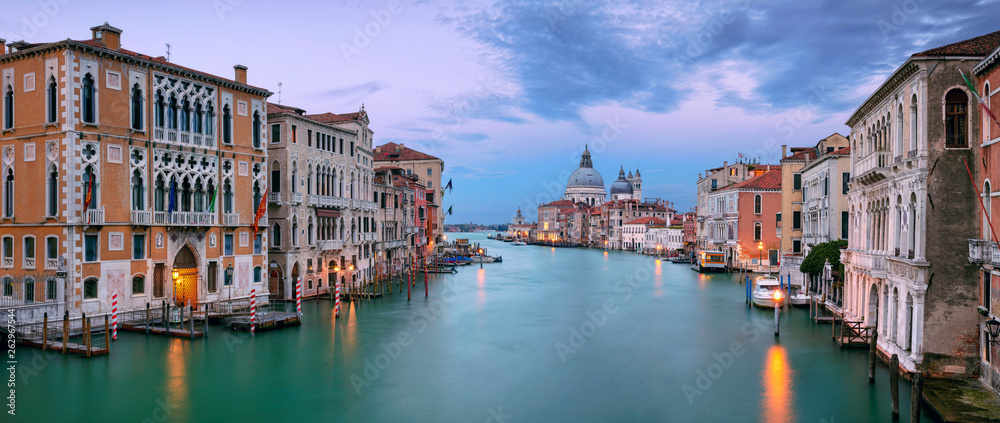 Venice, Italy. Panoramic cityscape image of Grand Canal in Venice, with Santa Maria della Salute Basilica in the background, during sunset