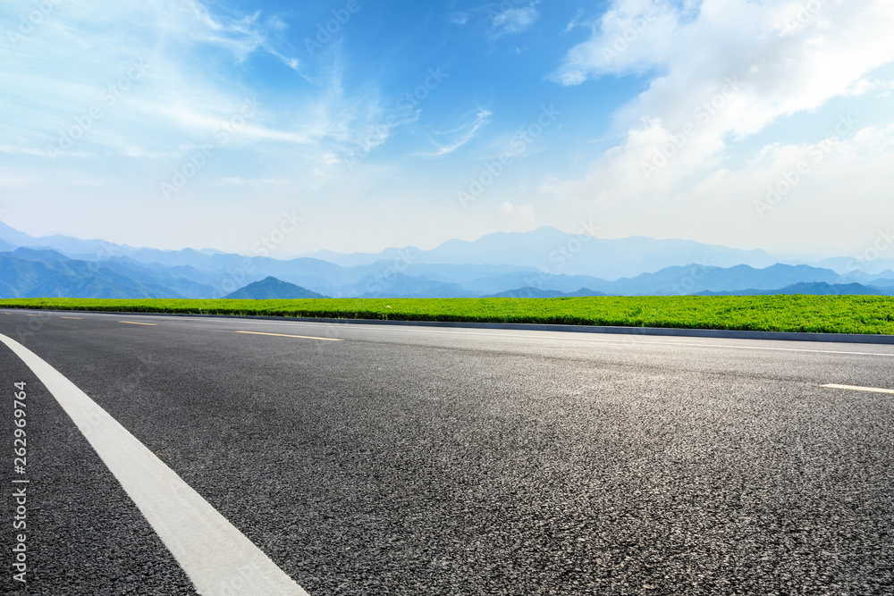 Empty asphalt road and mountains with beautiful clouds landscape