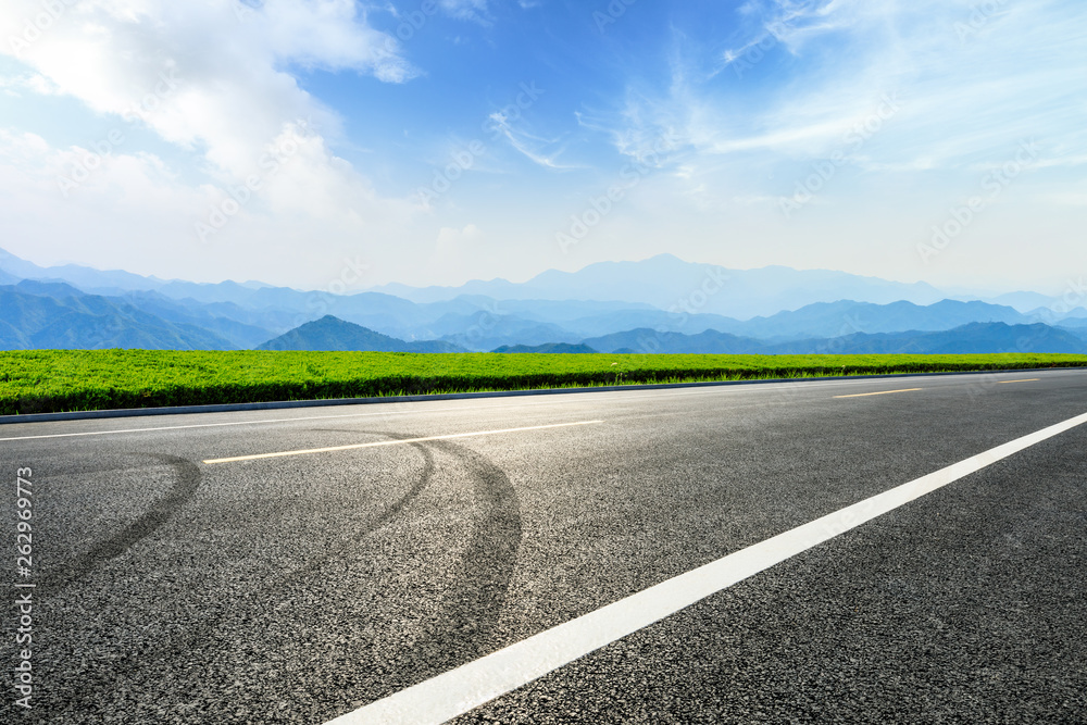 Empty asphalt road and mountains with beautiful clouds landscape