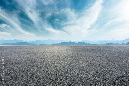 Empty asphalt road and mountains with beautiful clouds landscape © ABCDstock