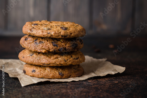 Coffee glass and milk with chocolate chip cookie on dark stone concrete table background. Morning Breakfast Concept. Copy space photo