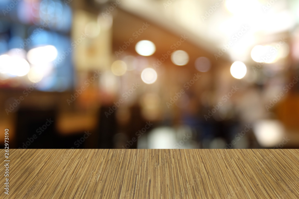 Empty dark wooden table in front of abstract blurred bokeh background of restaurant . can be used for display or montage your products.Mock up for space.