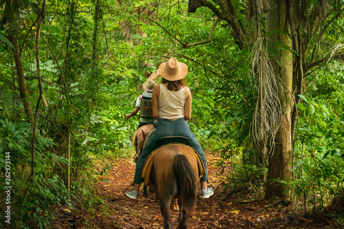 Fototapeta Naklejka Na Ścianę i Meble -  Horse ride through jungle in vacation.