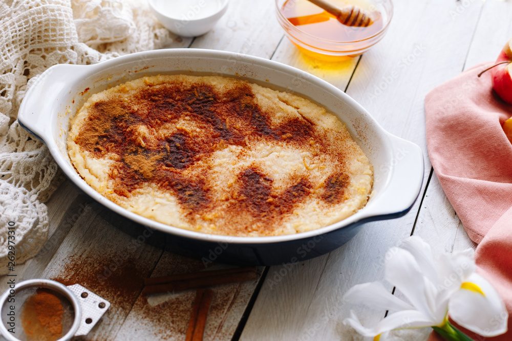 homemade casserole with honey, cinnamon and apples. Wooden white tables. Dessert. homemade casserole with honey, cinnamon and apples. Wooden white tables. Dessert.