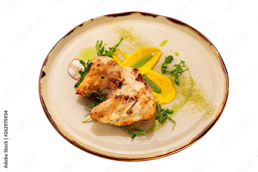 Grilled chicken breast served with sauce on a plate isolated at white background. Grilled chicken breast served with sauce on a plate isolated at white background.