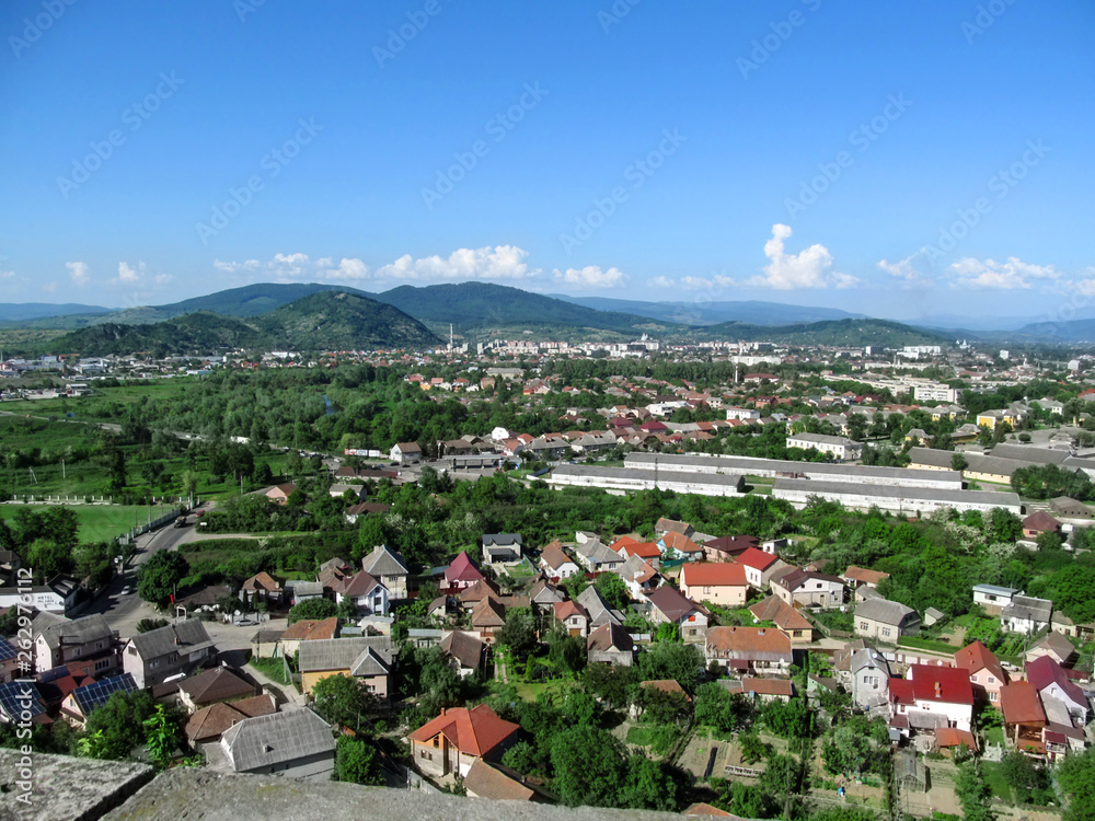 Mountain panorama of Mukachevo - view from the balcony of Palanok Castle. Beautiful spring and summer landscape of a small town in Transcarpathia (Ukraine)