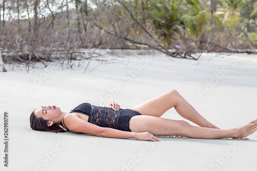Portrait of Asian woman wearing a swimsuit on the beach.
