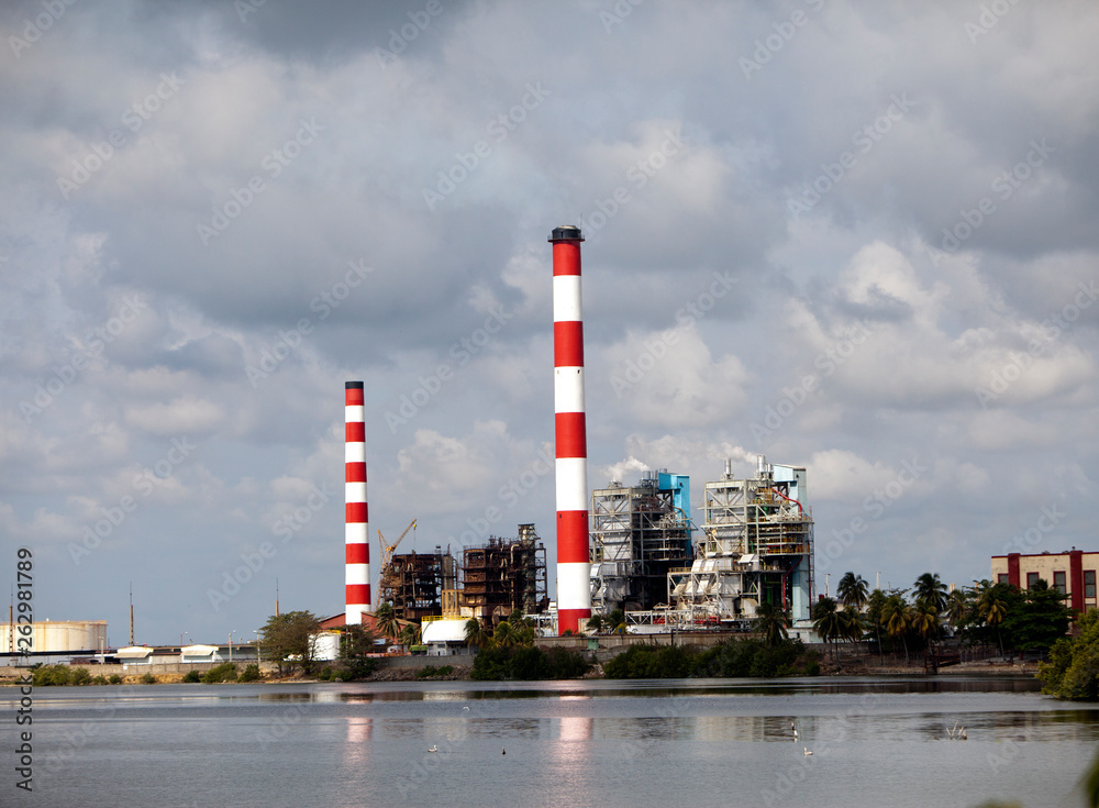 Cuba. Industrial factory buildings by the sea