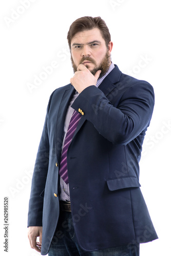 Portrait of a big handsome pensive bearded business man in a dark suit and a bright blue tie, isolated on white