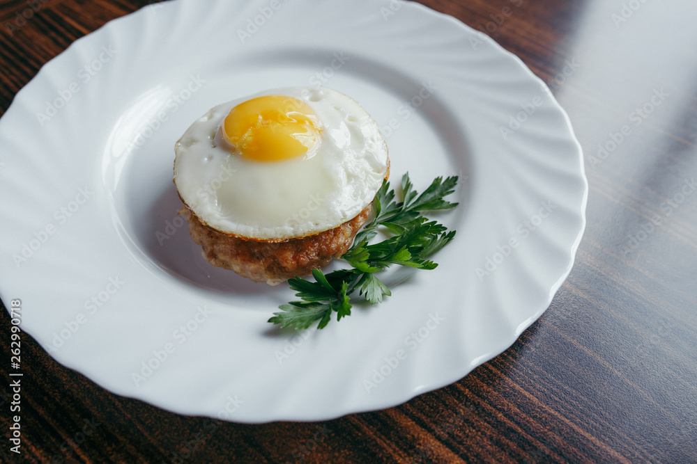 Fried Eggs on a plate wooden background Fried Eggs on a plate wooden background