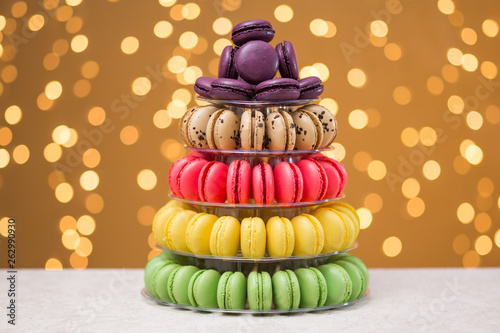 Bild auf Leinwand Multicolored macaroons in a shelf on a festive background