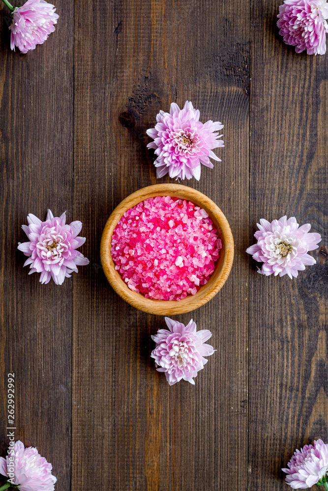 pink spa salt for aroma therapy with flower fragrance on wooden background top view